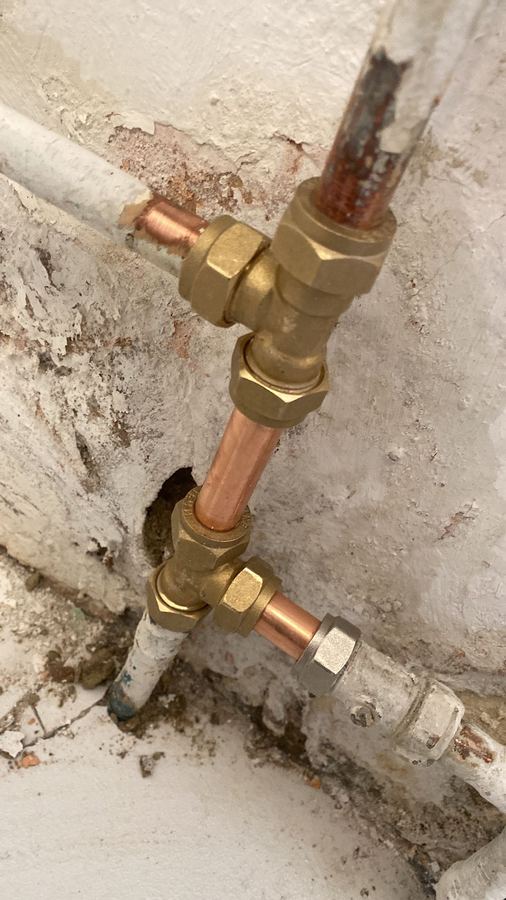Leaking pipe repaired with new copper and brass compression fittings
